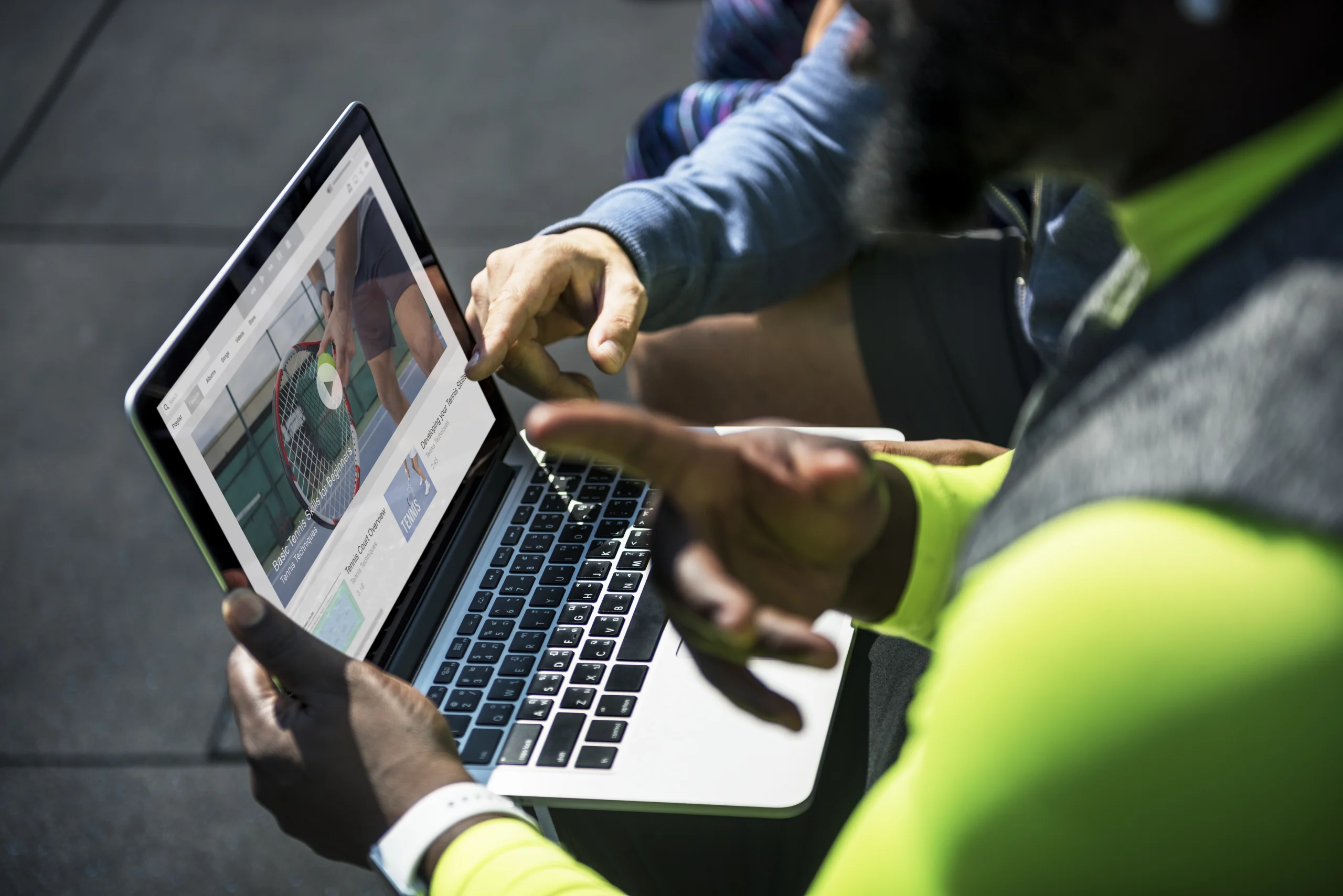 personnes qui regardent un clip video de tennis sur un appareil numerique